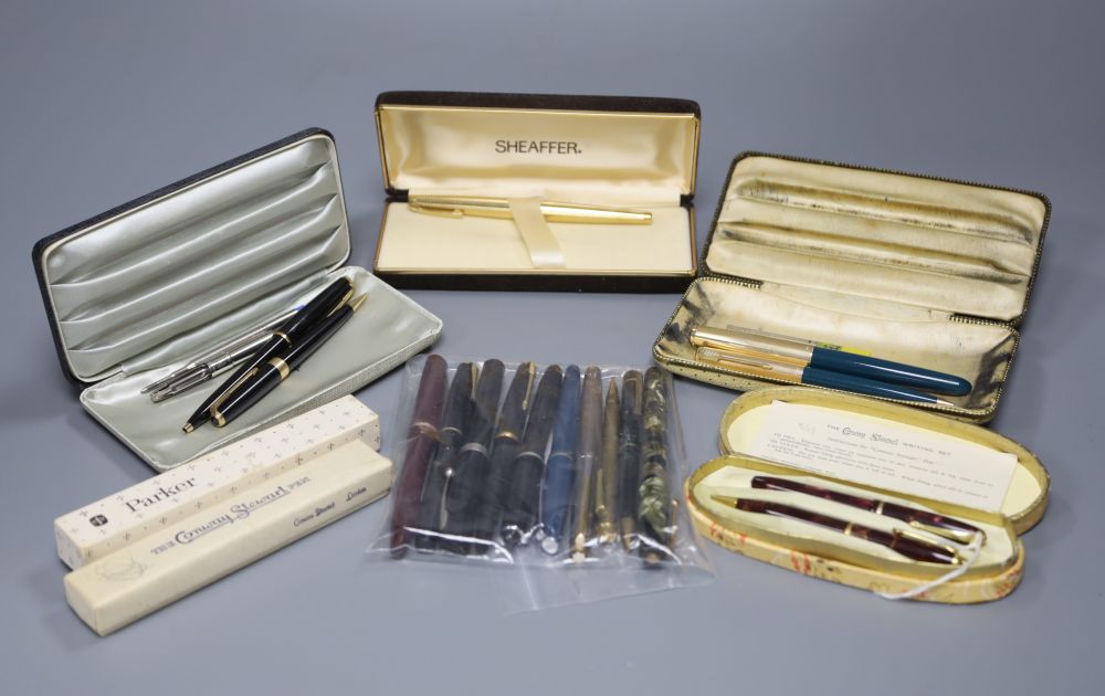 A collection of fountain pens, ballpoint pens and pencils,